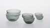 DECALES. Bowls with a convenient gripping thanks to the shape. Grey glass.<br />Dimensions : diameters 62mm, 110mm, 140mm, heights 57mm, 80mm, 100mm.<br /><br />Photographic credit : Xavier Nicostrate. - Laurence Brabant Alain Villechange