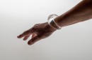 Poetic element of reverie and play like a child, this glass bangle mixes liquid and gas. The air bubble floats in the liquid and navigates according to the movements of the wrist. Far from a mechanical aesthetic, each piece, unique, requires great dexterity for its manufacture. Sculpted without mold each piece will be of an identical aesthetic but slightly variable dimensions. Easy to wear and adopt.<br />Photo credit : Xavier Nicostrate. - Laurence Brabant Alain Villechange