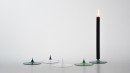 A LA POINTE. Candelholder with a masive glass point. As this glass is heat resistant, warm the point with a lighter and push the candle on the hot point. In grey, green, emerald, clear and in clear with black details.<br />Diameter 95mm.<br /><br />Photographic credit : Xavier Nicostrate. - Laurence Brabant Alain Villechange